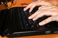 Close up woman working at home office,fingers typing using touch texting on a computer laptop keyboard Royalty Free Stock Photo