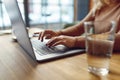 Close up of woman working on wireless laptop at cafe Royalty Free Stock Photo