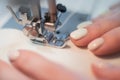 Close-up. A woman works on an electric sewing machine at home Royalty Free Stock Photo