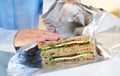 Close Up Of Woman Wrapping Sandwich In Non Reusable Aluminium Foil Royalty Free Stock Photo