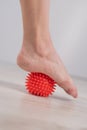 Close-up of a woman& x27;s foot on a massage ball with spikes. Royalty Free Stock Photo