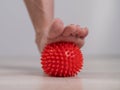 Close-up of a woman's foot on a massage ball with spikes. Royalty Free Stock Photo