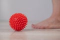 Close-up of a woman's foot on a massage ball with spikes. Royalty Free Stock Photo