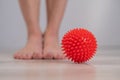 Close-up of a woman's foot on a massage ball with spikes. Royalty Free Stock Photo