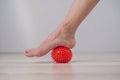 Close-up of a woman& x27;s foot on a massage ball with spikes. Royalty Free Stock Photo