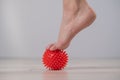 Close-up of a woman& x27;s foot on a massage ball with spikes. Royalty Free Stock Photo