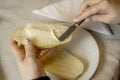 Close up of woman& x27;s hand buttering bread Royalty Free Stock Photo