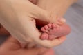 Close-up of woman& x27;s hand holding newborn baby& x27;s foot. Royalty Free Stock Photo