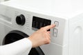 Close-up of a woman& x27;s hand that presses and turns off the washing machine Royalty Free Stock Photo