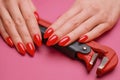 Close-up of a woman& x27;s hand with a red manicure and a plumbing wrench. Royalty Free Stock Photo
