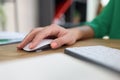 Close-up of woman& x27;s hand resting on modern wireless computer mouse. Royalty Free Stock Photo