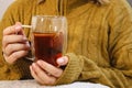 Close up of woman& x27;s hands holding a glass cup with hot tea with lemon and honey Royalty Free Stock Photo