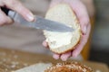 Close-up of woman& x27;s hands spreading butter on a slice of bread. Quick food for hiking or if you don& x27;t have time Royalty Free Stock Photo