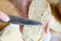 Close-up of woman& x27;s hands spreading butter on a slice of bread. Quick food for hiking or if you don& x27;t have time Royalty Free Stock Photo
