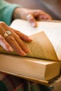 Close-up of a woman's hands turning pages of a book Royalty Free Stock Photo