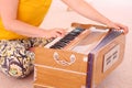 Close up of a woman in a yellow T-Shirt playing the Indian harmonium.