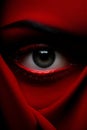 a close up of a womans eye with a red scarf Royalty Free Stock Photo