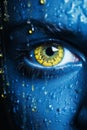 a close up of a womans face painted blue with yellow eyes Royalty Free Stock Photo