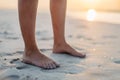 Close-up of womans feet in sand, at sea. Royalty Free Stock Photo