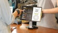 Close up of woman customer hand ordering coffee with barista, waitress, small busineaa owner at counter in coffee shop cafe