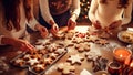 Close up of women decorating christmas gingerbread cookies at home
