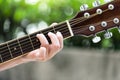 A close up of women fingers playing guitar