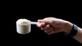 Close up of women hand holding a measuring scoop of whey protein  preparing protein shake Royalty Free Stock Photo