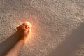 Close up women hand touches a white concrete wall with sunshine, shade and shadow in the morning. Copy space for text.