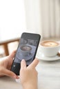 Close up of women hands take a picture coffee in coffee shop