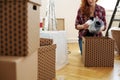 Close-up on woman protecting the vase with foil while packing into boxes