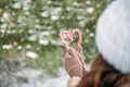 Close-up of women\'s hands holding candy canes in the form of heart. Royalty Free Stock Photo