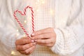 Close-up of women`s hands holding candy canes in the form of heart Royalty Free Stock Photo