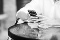 Close up of women`s hands holding cell telephone. Back-and-white image Royalty Free Stock Photo