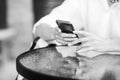 Close up of women`s hands holding cell telephone. Back-and-white image Royalty Free Stock Photo