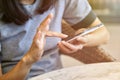 Close up of women`s hands holding cell telephone and browse mobile screen with her index finger. Royalty Free Stock Photo