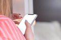 Close up of women`s hands holding cell telephone with white scre Royalty Free Stock Photo