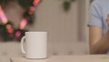 Close-up of women`s hands pouring tea on background of lights. Stock footage. Young woman makes herself cup of tea Royalty Free Stock Photo