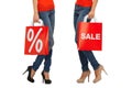 Close up of women with sale sign on shopping bag Royalty Free Stock Photo