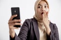 close up women wearing suits hijab surprised looking at the phone, formal work concept