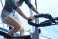 Close-up women working out in gym on the exercise bike,