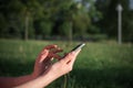 Close up of women's hands holding cell telephone outdoor with blank copy space scree for your advertising text message Royalty Free Stock Photo