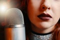 Female singer with disco mic on bokeh light background. Royalty Free Stock Photo