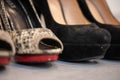 A close up of a women& x27;s shoe, snake leather peep toe and black suede pumps Royalty Free Stock Photo