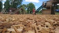 Close up of wood chippings and children playing on a playground Royalty Free Stock Photo