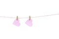 Wood clothes pins with two blank pink paper in heart shaped hanging on brown rope isolated on white background., clipping path Royalty Free Stock Photo