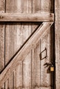 Close-up of wood door to an old house bolted shut with flat gold