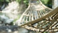 Close up of wood hammock hanging in summer garden. Cozy hygge place for weekend relax in garden Royalty Free Stock Photo
