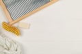 Close up of wood and metal washboard or wash board with brush, piece of washing soap and white shirt on white wooden table