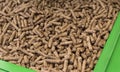 Wood pellets in green container Royalty Free Stock Photo