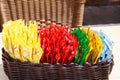 Close up of wooden basket with choice of small colorful plastic packages of sauces on table of restaurant outdoor Royalty Free Stock Photo